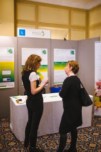 Anitia Hogg, Lead for Pharmaceutical Clinical Effectiveness, MOIC, with a visitor at the MOIC stand.